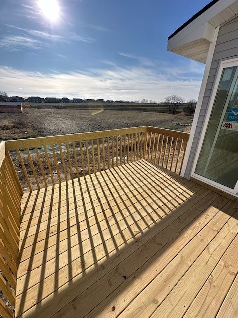 wooden deck featuring a rural view