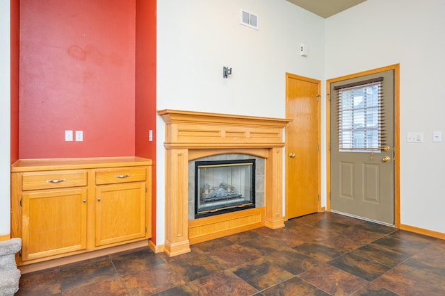 unfurnished living room featuring a tiled fireplace