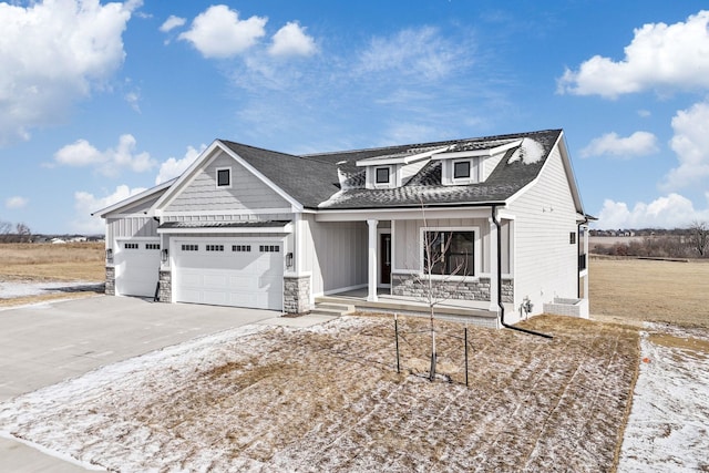 view of front of house featuring a garage and a porch