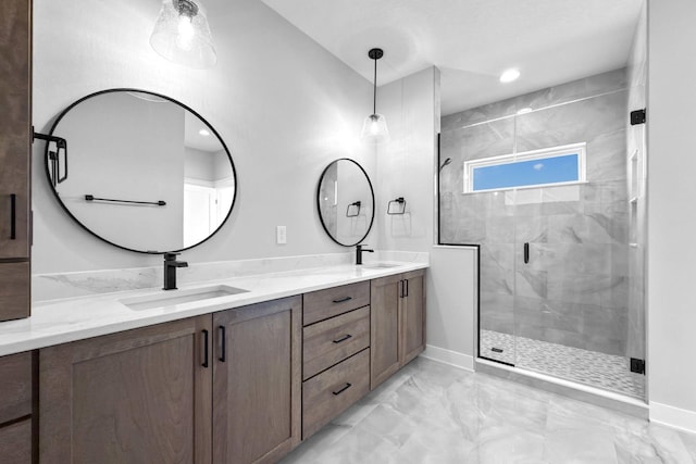 bathroom with a shower with door and vanity