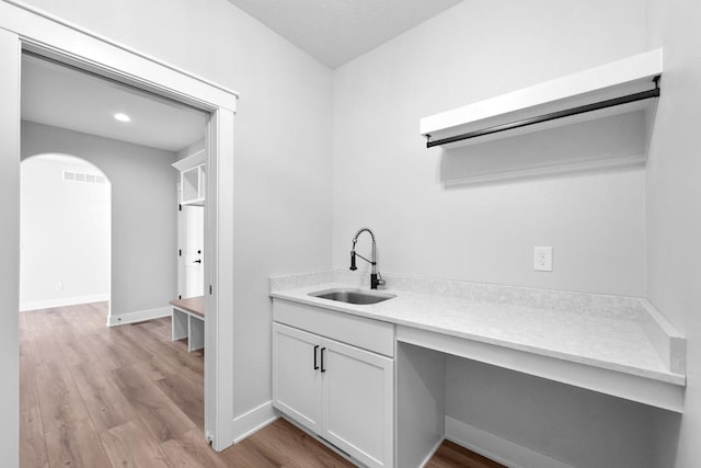 washroom featuring sink and light wood-type flooring