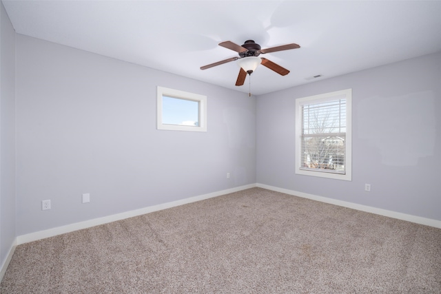 spare room featuring baseboards, carpet, and a ceiling fan