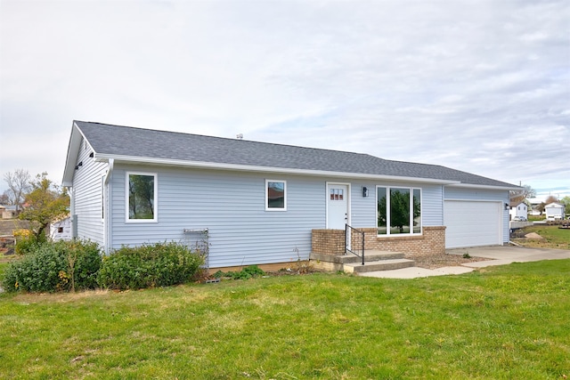 back of house with a yard and a garage