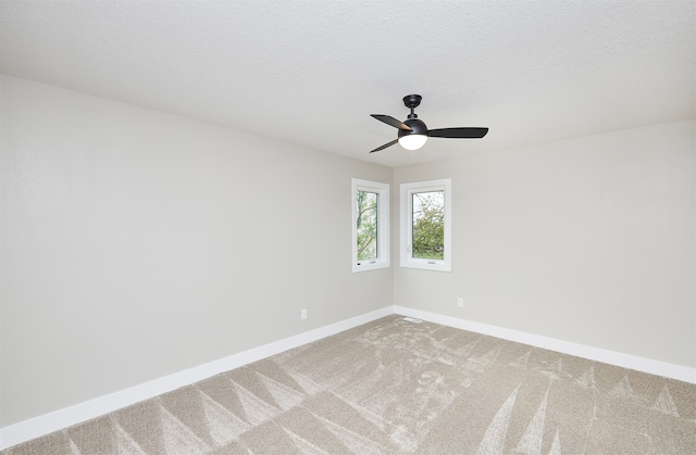 spare room featuring carpet flooring and a textured ceiling