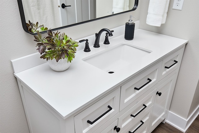 bathroom with hardwood / wood-style floors and vanity