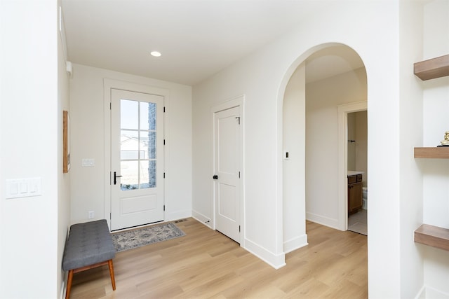 foyer entrance with light hardwood / wood-style floors