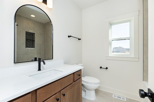 full bathroom featuring tile patterned flooring, toilet, vanity, visible vents, and baseboards