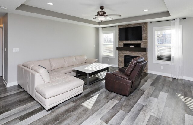 812 SE 15th St, Grimes, IA 50111 - living area with a raised ceiling, baseboards, wood finished floors, and recessed lighting