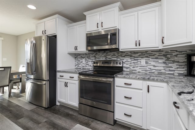 kitchen featuring white cabinetry, stainless steel appliances, and dark wood-type flooring