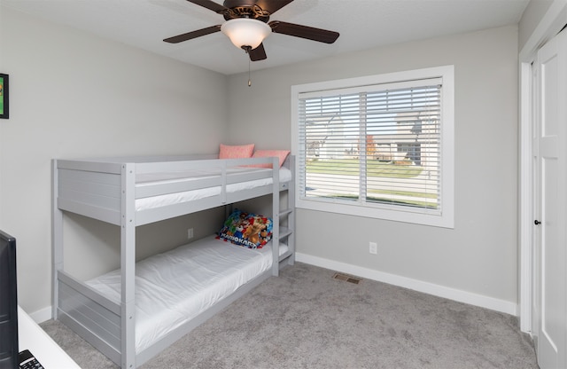 unfurnished bedroom with light colored carpet and ceiling fan