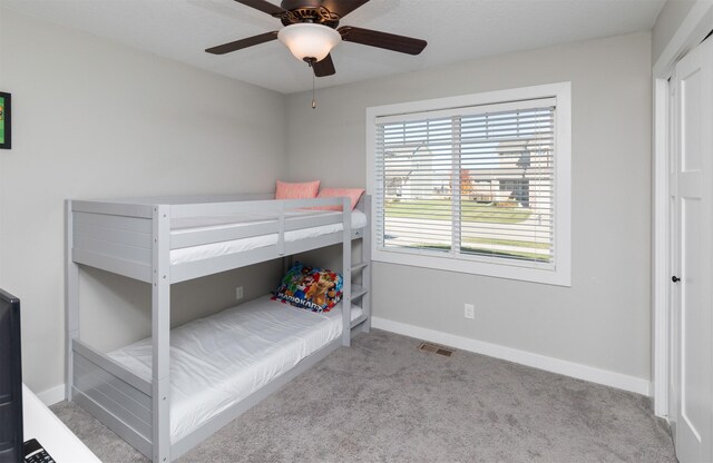 812 SE 15th St, Grimes, IA 50111 - carpeted bedroom with baseboards and a ceiling fan