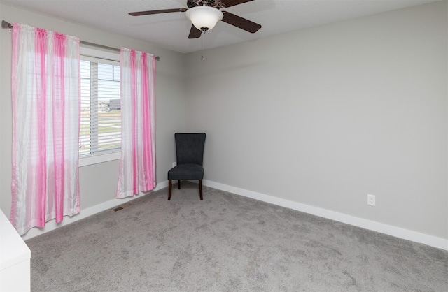 sitting room with ceiling fan and light colored carpet