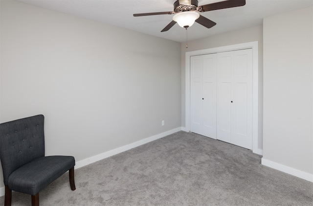 living area featuring light carpet