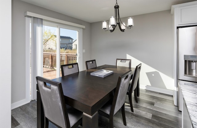 dining area with an inviting chandelier and dark wood-type flooring