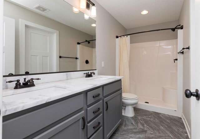 812 SE 15th St, Grimes, IA 50111 - bathroom featuring a shower with shower curtain, toilet, double vanity, recessed lighting, and baseboards