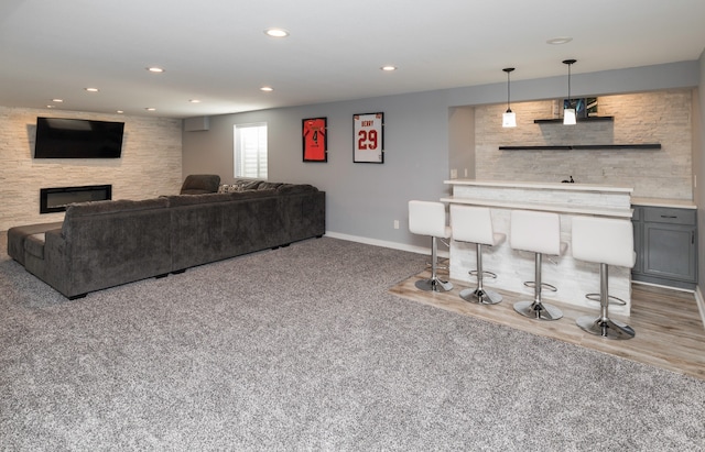 carpeted living room featuring a fireplace