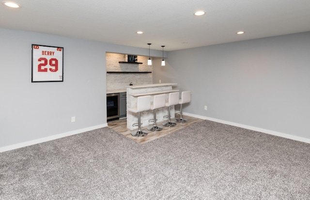 812 SE 15th St, Grimes, IA 50111 - living area with wet bar, light colored carpet, baseboards, recessed lighting, and beverage cooler