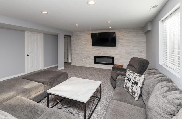 812 SE 15th St, Grimes, IA 50111 - carpeted living area with a glass covered fireplace, recessed lighting, healthy amount of natural light, and baseboards