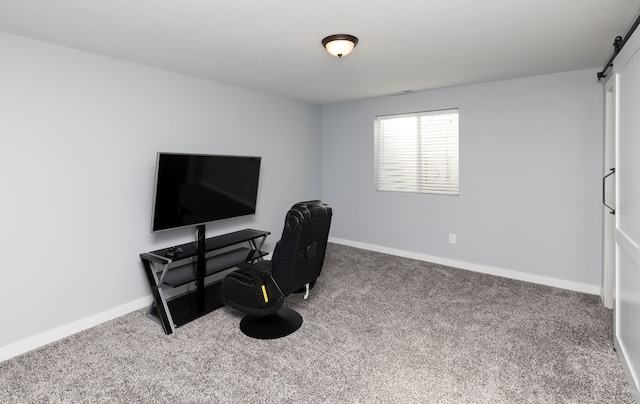 office featuring carpet and a barn door