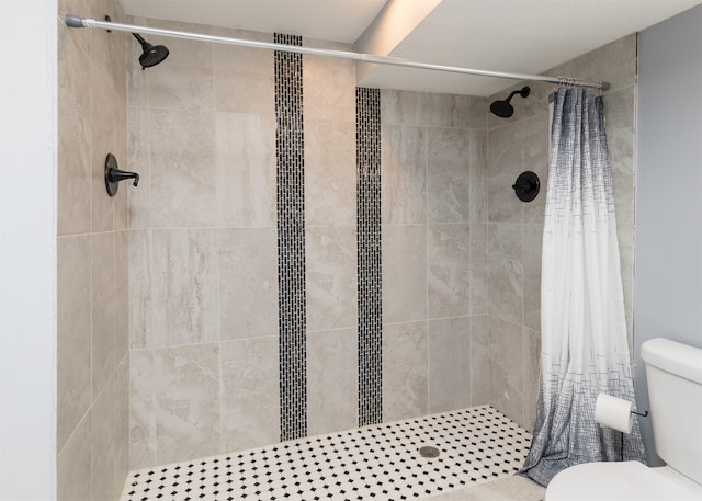 bathroom with toilet and a shower with shower curtain