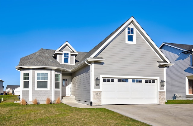 view of front facade with a garage and a front lawn