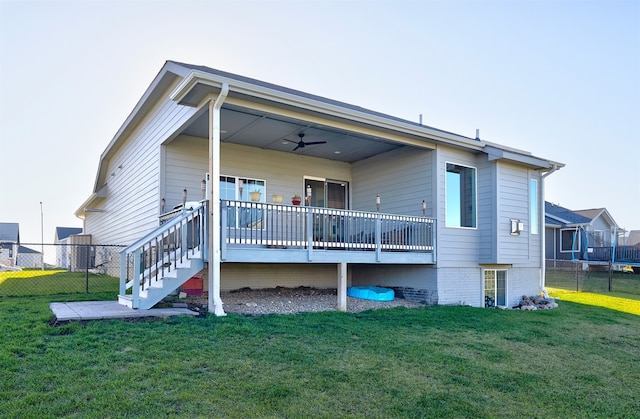 back of property featuring a yard, ceiling fan, and a wooden deck