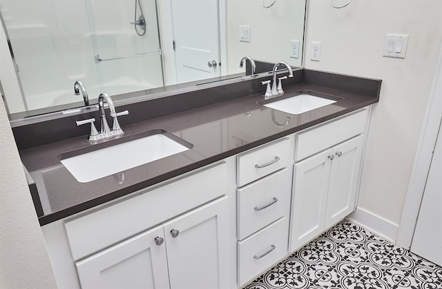 bathroom with vanity and a shower with door