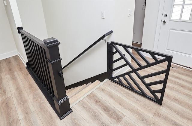 stairway featuring wood-type flooring