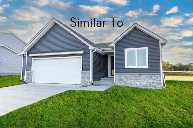 view of front of property featuring a garage and a front yard