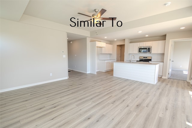 unfurnished living room with sink, ceiling fan, and light wood-type flooring