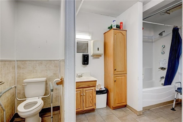 full bathroom featuring vanity, shower / washtub combination, tile walls, tile patterned flooring, and toilet