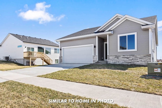 craftsman-style house featuring a front yard, central AC, and a garage