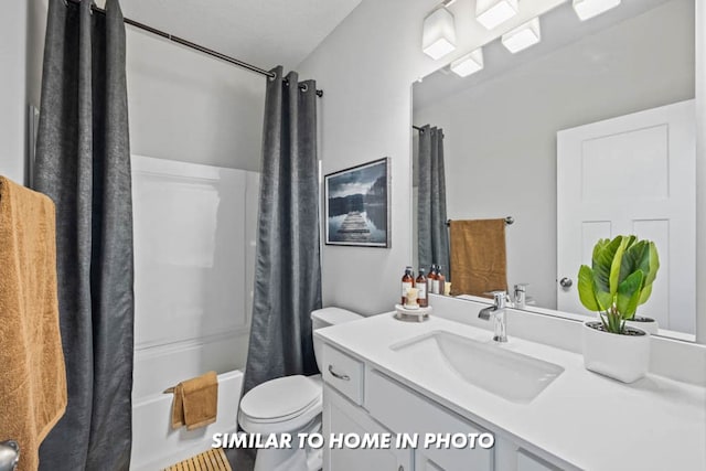 full bath with vanity, shower / tub combo, and toilet