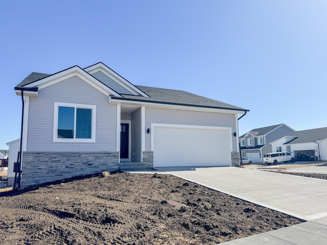 ranch-style home with stone siding, concrete driveway, and an attached garage