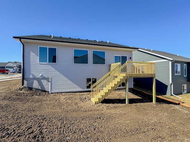 back of house featuring a deck and stairs