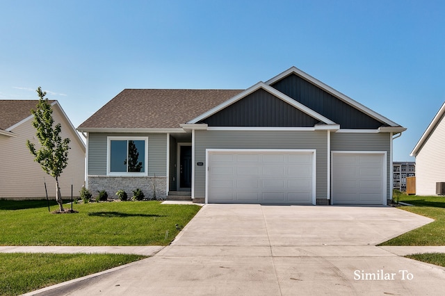 craftsman-style house featuring a garage and a front lawn