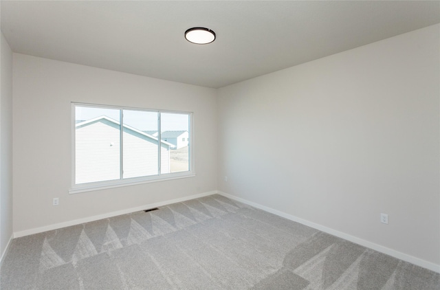 empty room with visible vents, stairway, baseboards, and carpet