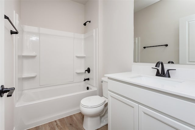 bathroom with bathtub / shower combination, toilet, wood finished floors, and vanity