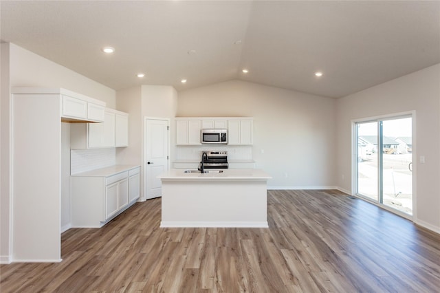 kitchen with white cabinetry, an island with sink, light wood-type flooring, and appliances with stainless steel finishes