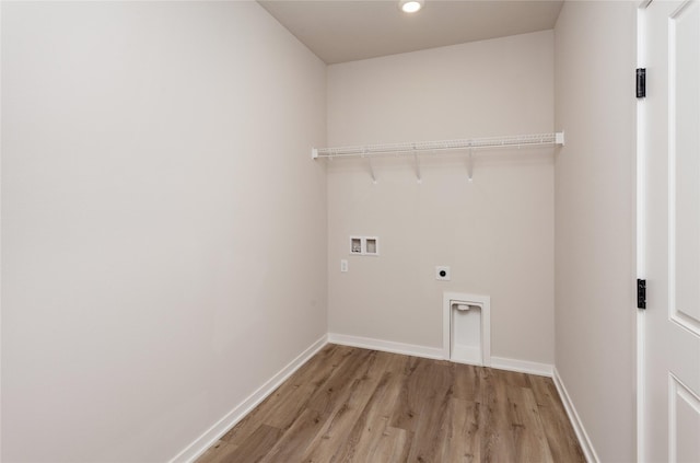 laundry area with laundry area, electric dryer hookup, baseboards, and washer hookup