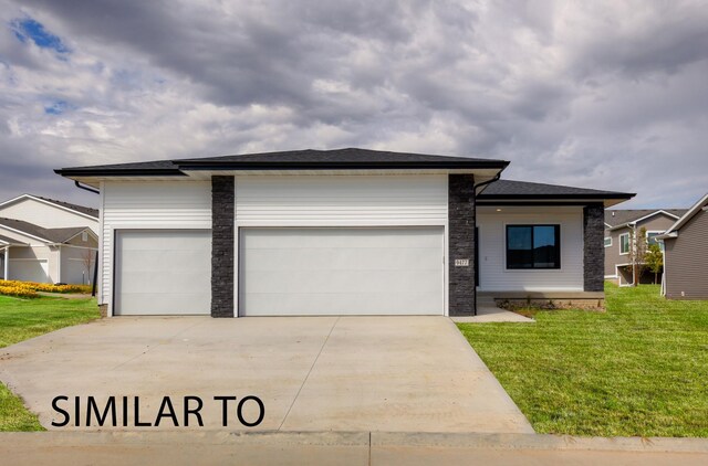 view of front of property featuring a garage and a front yard