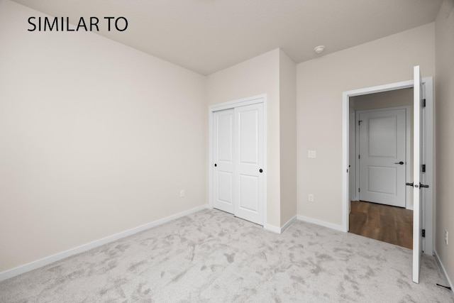 unfurnished bedroom with a closet, baseboards, and carpet