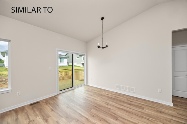 unfurnished dining area with lofted ceiling, light wood-style flooring, and visible vents