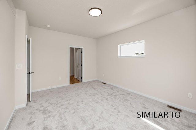 unfurnished bedroom featuring carpet flooring, baseboards, and visible vents