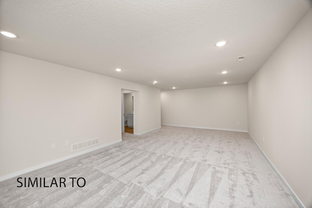 unfurnished room featuring light colored carpet, recessed lighting, visible vents, and baseboards