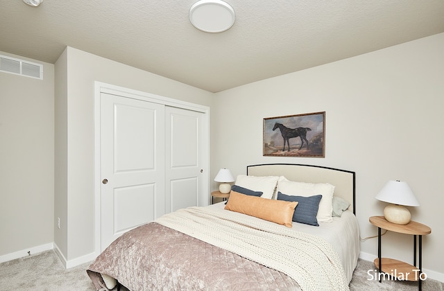 bedroom with a closet and light colored carpet