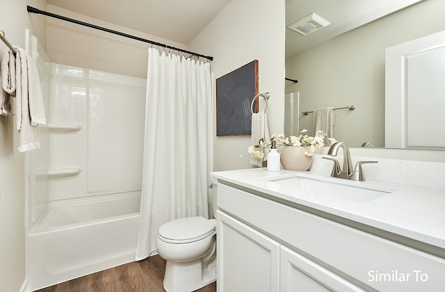 full bathroom featuring vanity, hardwood / wood-style flooring, toilet, and shower / bath combo with shower curtain