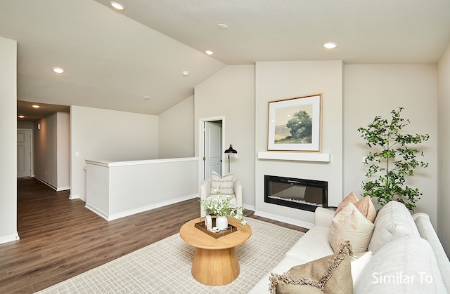 living room featuring dark hardwood / wood-style flooring and lofted ceiling