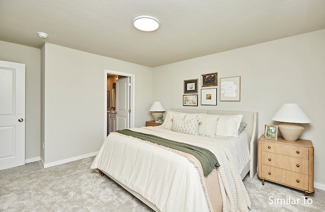 carpeted bedroom with ensuite bathroom