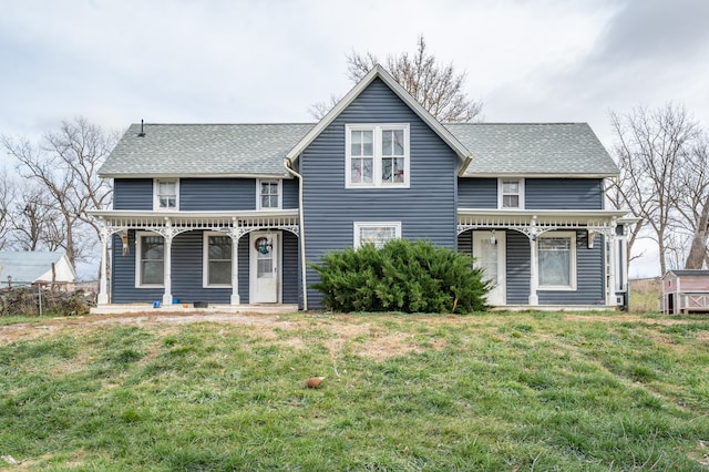 view of front of home with a front yard and covered porch